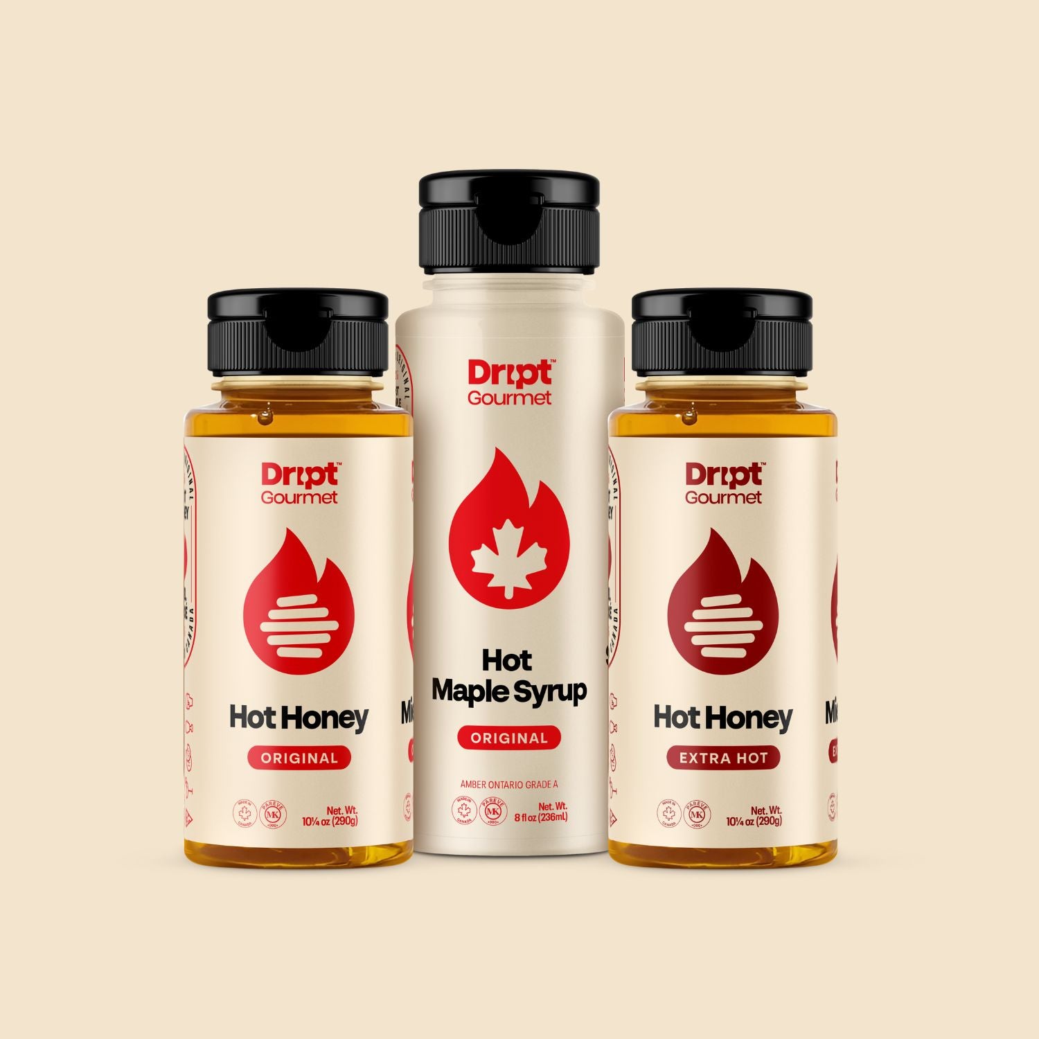 Dript Gourmet Hot box contents. Original hot honey, extra hot honey, original hot maple syrup containers to a beige background.